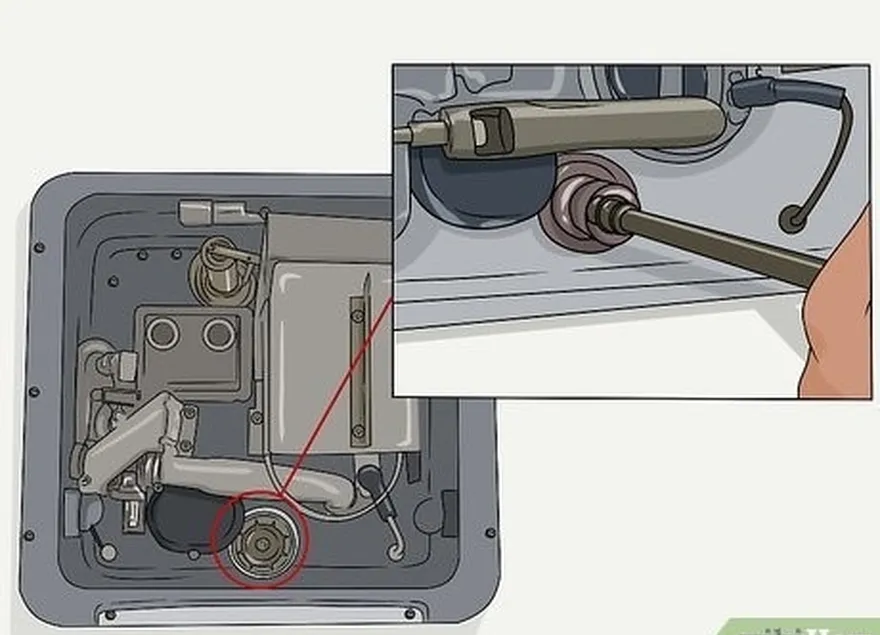 addım 4 tankı açır's plug or anode rod with a socket wrench.